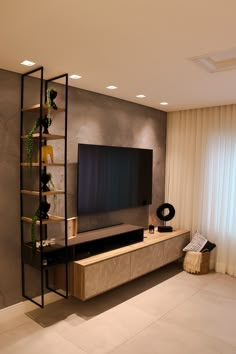 a living room with a large flat screen tv mounted to the side of a wall