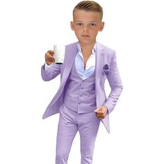 a young boy in a purple suit holding a coffee cup