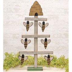 a wooden beehive with three bees on it