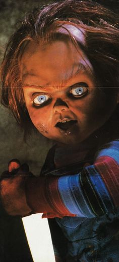 an image of a creepy doll with big blue eyes