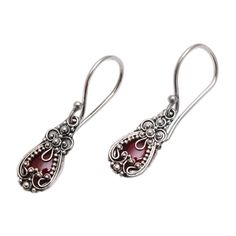 Silver blossoms crown garnets in exquisitely feminine earrings. Balinese designer Made Sriasih creates a beautiful illusion. The sparkling gems are set in sterling silver. Sterling silver and garnet Hook earrings Combination finish Natural stone - some variations in color and/or pattern are to be expected Handmade in Indonesia Red Sterling Silver Filigree Earrings, Ornate Red Sterling Silver Earrings, Elegant Garnet Teardrop Earrings, Garnet Gemstone Earrings, Handmade Elegant Garnet Earrings, Classic Silver Garnet Earrings, Elegant Ruby Earrings Nickel-free, Elegant Handmade Garnet Earrings, Elegant Ruby Earrings Nickel Free