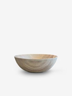 a wooden bowl sitting on top of a white table