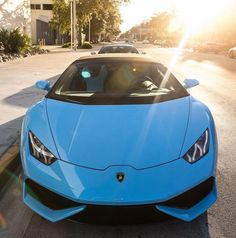 a blue sports car is parked on the street