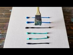 the paintbrushes are lined up on the canvas to be used as art work