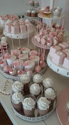 a table topped with lots of cakes and cupcakes