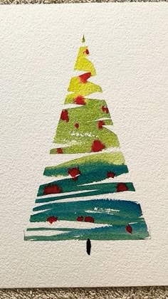 a christmas tree made out of watercolor paper