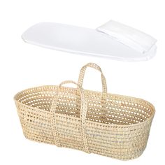 an empty wicker basket with a white pillow on the top and bottom, sitting next to it