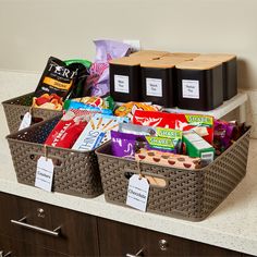 two baskets filled with snacks on top of a counter