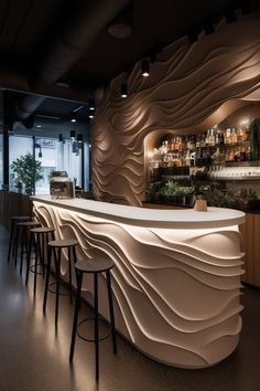 the interior of a modern restaurant with curved white counter tops and bar stools in front of it