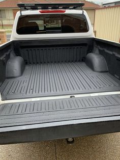 the back end of a pickup truck with its cargo compartment open