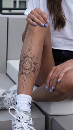 a woman's leg with a tattoo on it