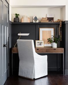 a white chair sitting in front of a wooden desk