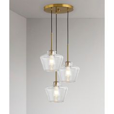 three clear glass pendant lights hanging from a ceiling