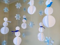 paper snowman decorations hanging from the ceiling