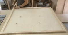 a person working on a wooden table in a kitchen