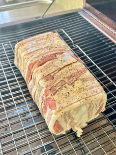 a piece of raw meat sitting on top of a grill