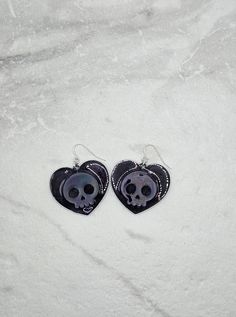 These light-weight skull heart earrings are perfect for the bad-ass babes who fancy a bit of sparkle. Made with resin, these earrings have a holographic effect that will make your outfit POP! Treat yourself to a pair of these skull dangle earrings and upgrade your style game. #Glowup! Ready to ship in 1 - 3 business days Handmade with a shit ton of love from our studio in NJ Edgy Nickel-free Skull Earrings, Punk Skull Print Earrings Gift, Punk Skull Print Earrings For Gift, Punk Style Skull Print Earrings As Gift, Edgy Skull-shaped Earrings For Gift, Edgy Skull Shaped Earrings For Gift, Gothic Skull Print Earrings For Gift, Gothic Skull Print Earrings As Gift, Edgy Skull-shaped Pierced Earrings