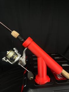 a fishing rod and reel attached to the back of a car trunk with a black background