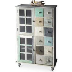 a multicolored cabinet with many drawers on it's front and side doors