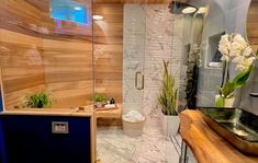 a bathroom with wood paneling and glass walls