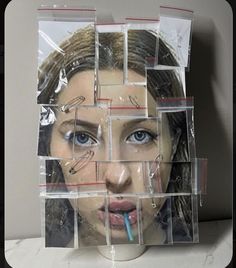 a woman's face is surrounded by plastic wrappers and toothbrushes in the shape of squares