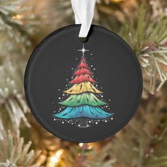 a colorful christmas tree ornament hanging from a christmas tree