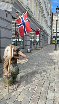 a statue of a man holding a flag on the street