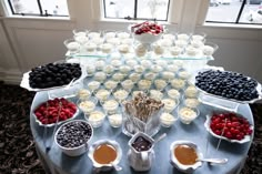 a table topped with lots of desserts and fruit on top of eachother