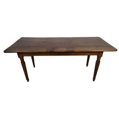 an old wooden table with two legs and a brown stain on the top, against a white background