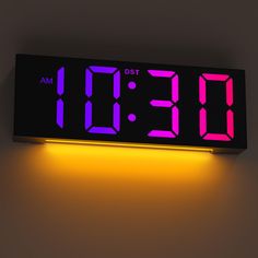 a digital clock with the time displayed on it's display panel is lit up