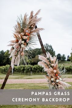 an outdoor ceremony with pampas grass and flowers