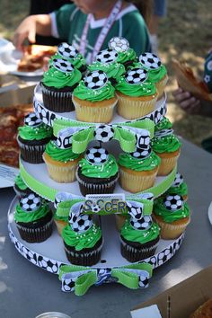 cupcakes are stacked on top of each other at a soccer themed birthday party