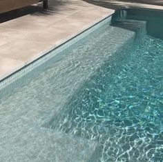 an empty swimming pool with clear blue water