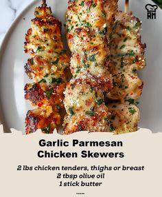 grilled chicken skewers on a white plate with text overlay that reads garlic parmesan chicken skewers