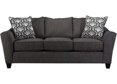 a gray couch with black and white pillows