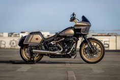 a gold and black motorcycle parked on top of a parking lot