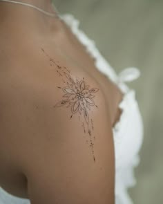 a woman with a flower tattoo on her shoulder