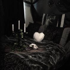 a black and white photo of a bed with candles on it