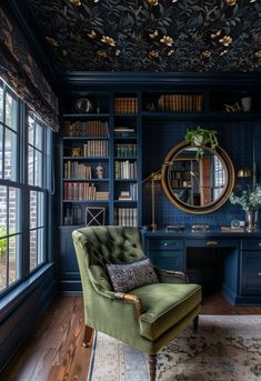 a green chair sitting in front of a desk with a mirror on top of it