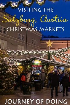 the front cover of a christmas market with people walking around it and lights on trees