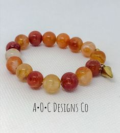 10mm round orange crab fire agate beads Gold plated charm Adjustable Orange Gemstone Bead Bracelet, Beaded Agate Stretch Bracelet, Orange Polished Beads Bracelet, Orange Round Faceted Beads Jewelry, Handmade Orange Agate Beaded Bracelets, Adjustable Orange Natural Stone Beaded Bracelets, Adjustable Orange Beaded Bracelets With Natural Stones, Orange Hand-strung Jewelry With Round Beads, Hand-strung Orange Jewelry With Round Beads