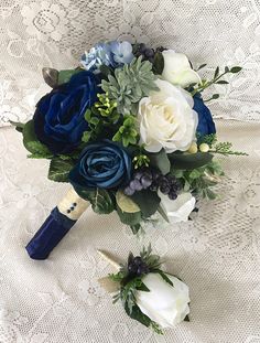 a bridal bouquet with blue and white flowers on a lace tablecloth, ready to be used as a bride's bouquet