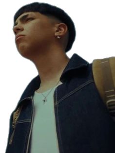 a young man wearing a denim jacket looking up