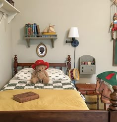 a teddy bear sitting on top of a bed in a room with bookshelves