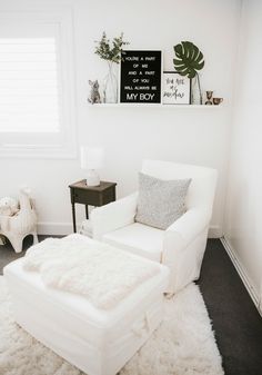 a white chair and ottoman in a small room