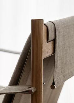 a close up view of the back of a chair with wood frame and armrests