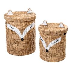 two wicker baskets with white foxes painted on the side and one has black eyes