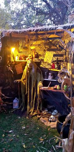 an outdoor halloween decoration with scarecrows and pumpkins in the yard at night