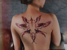 a woman with a bird tattoo on her back