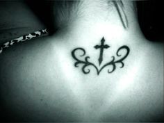 a cross tattoo on the back of a woman's neck